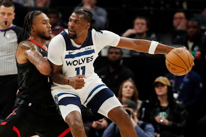Feb 4, 2024; Minneapolis, Minnesota, USA; Minnesota Timberwolves center Naz Reid (11) drives to the basket against Houston Rockets guard Cam Whitmore (7) in the fourth quarter at Target Center.